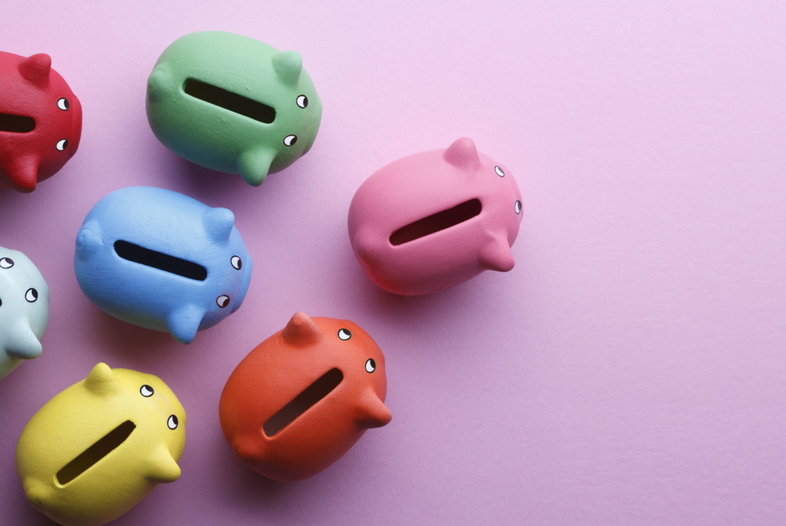 Top view of piggy banks over pink background.