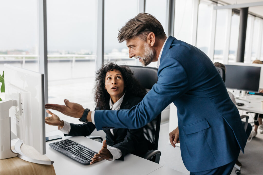 Business woman and businessman having a heated discussion